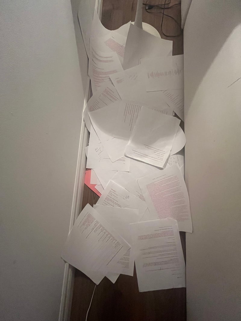 a pile of papers in a hallway
