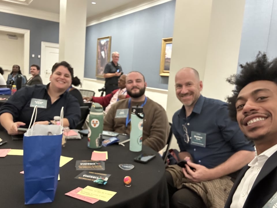 a picture of a group of four people smiling at a table.