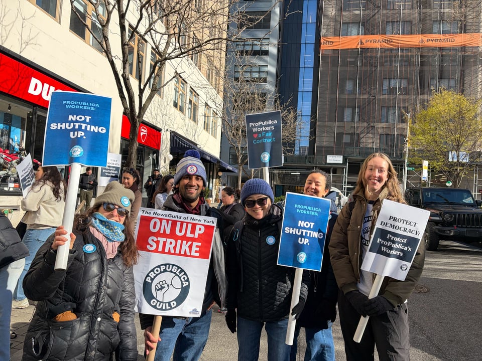 Five people hold protest signs on a New York City street. They read: "Not Shutting Up" and "On ULP Strike - ProPublica Guild". The workers are smiling.