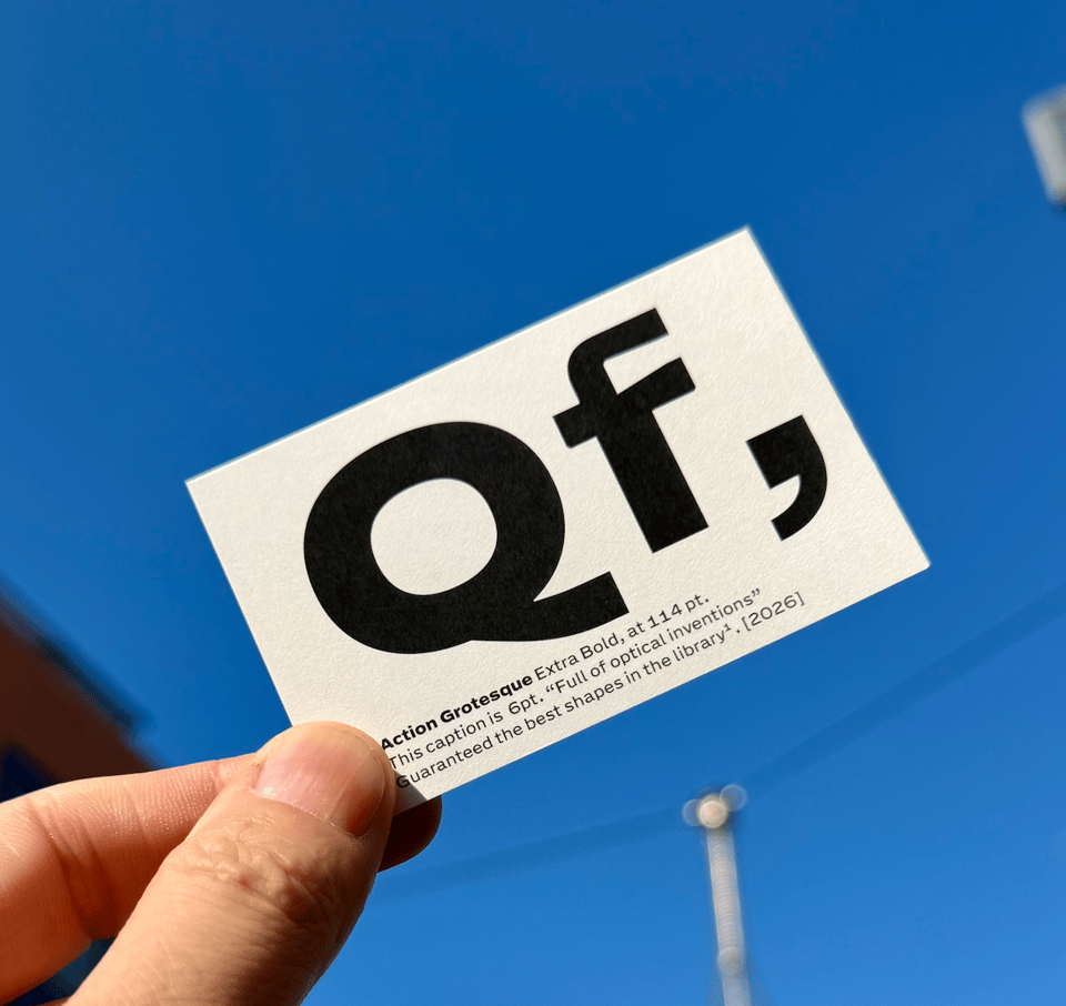 A hand holding up a business card. An odd way to look at a business card, really, but anything goes to make pretty photos. The crisp black letters on the white card against the blue sky are pretty intense.
