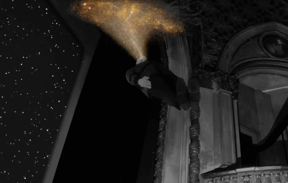 in a mysterious theater with stars on the screen, a man levitates, stiff as a board. he is releasing a golden cloud of lights from his head.