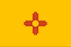 New Mexico State Flag. Red Zia symbol on gold background.