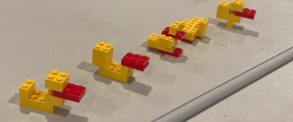 A photo of LEGO ducks all in a row