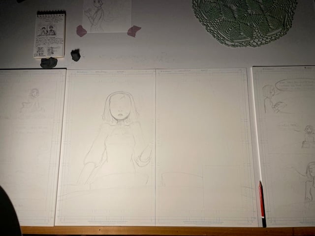 photo of my drafting table with an in-progress two-page spread on it