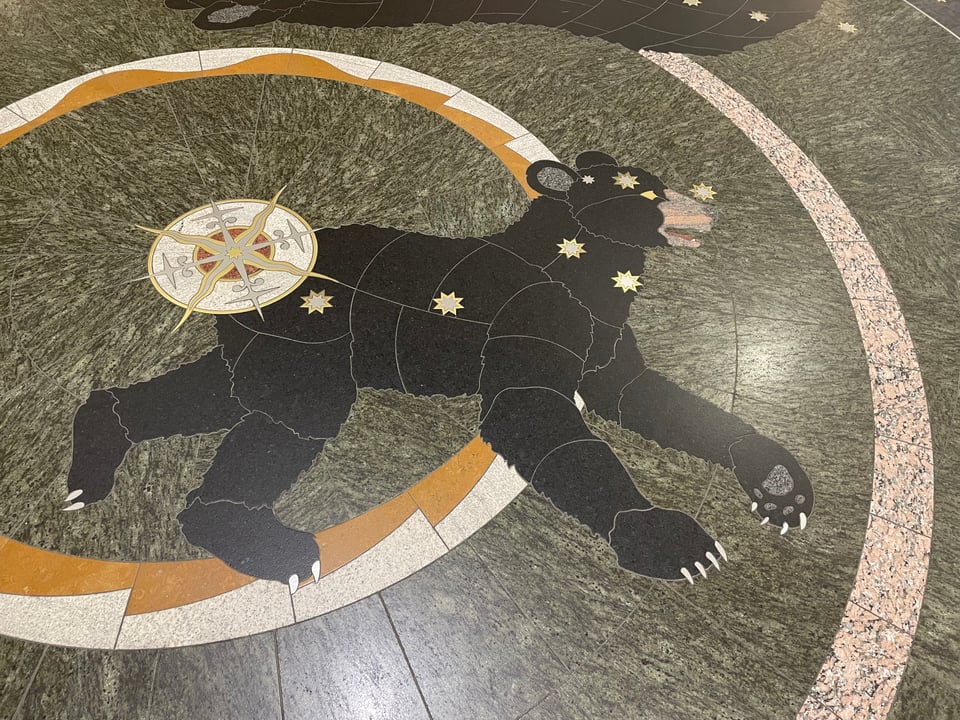 Artwork embedded in the floor of the Minneapolis-St Paul International Airport. It's an illustration of the constellation Ursa Minor depicted as a bear that looks dazed and has a giant exploding star on its butt