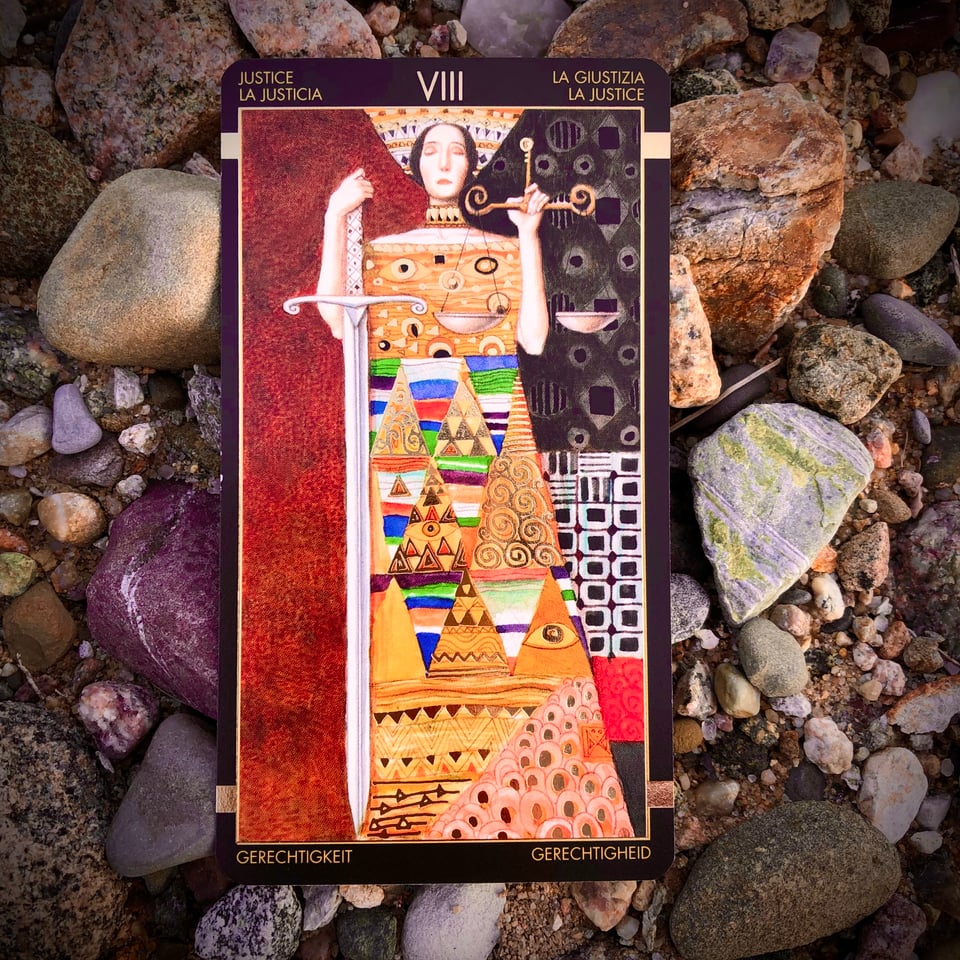 Justice, the queen of Libran energy, from the Golden Tarot of Klimt ... a geometric painting against a rocky backdrop