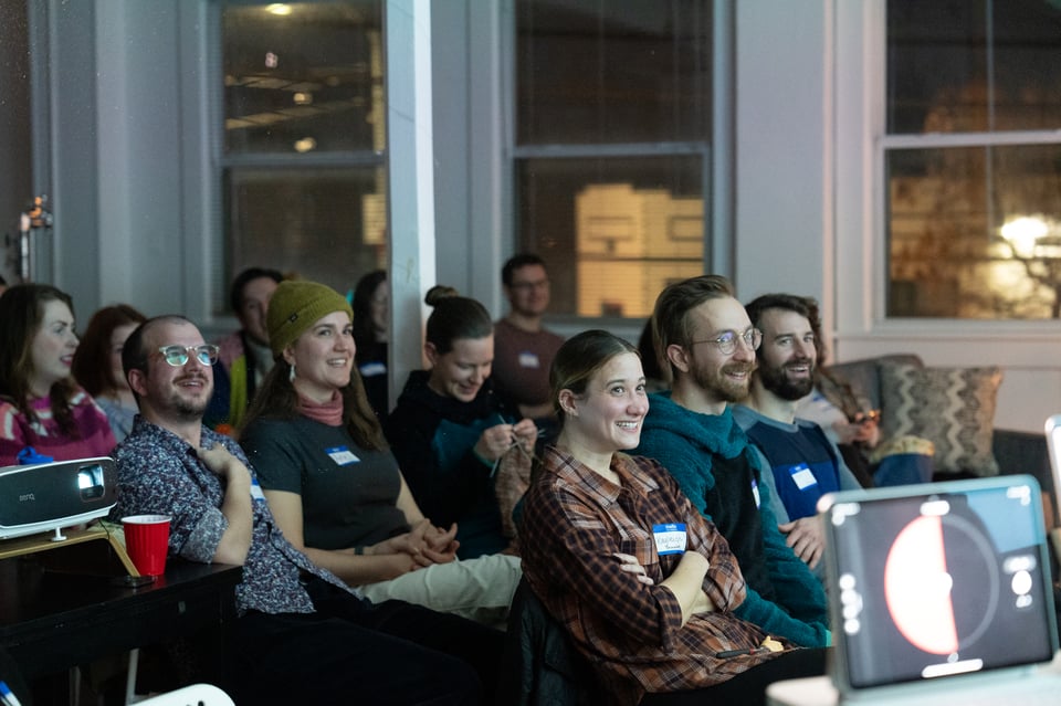 PowerPoint Party crowd laughing.