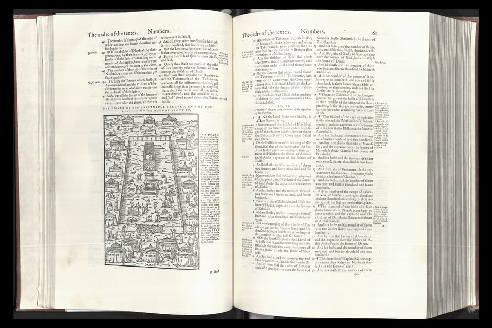 [Another spread of a bible, this one smaller with smaller type, and a slender column of footnotes running along both sides of the margins.]
