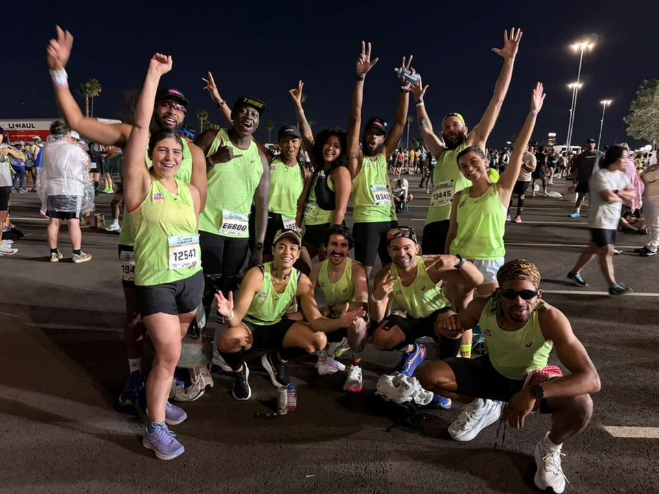 The ATCR crew pre-race, looking stoked with our hands up, cheering.