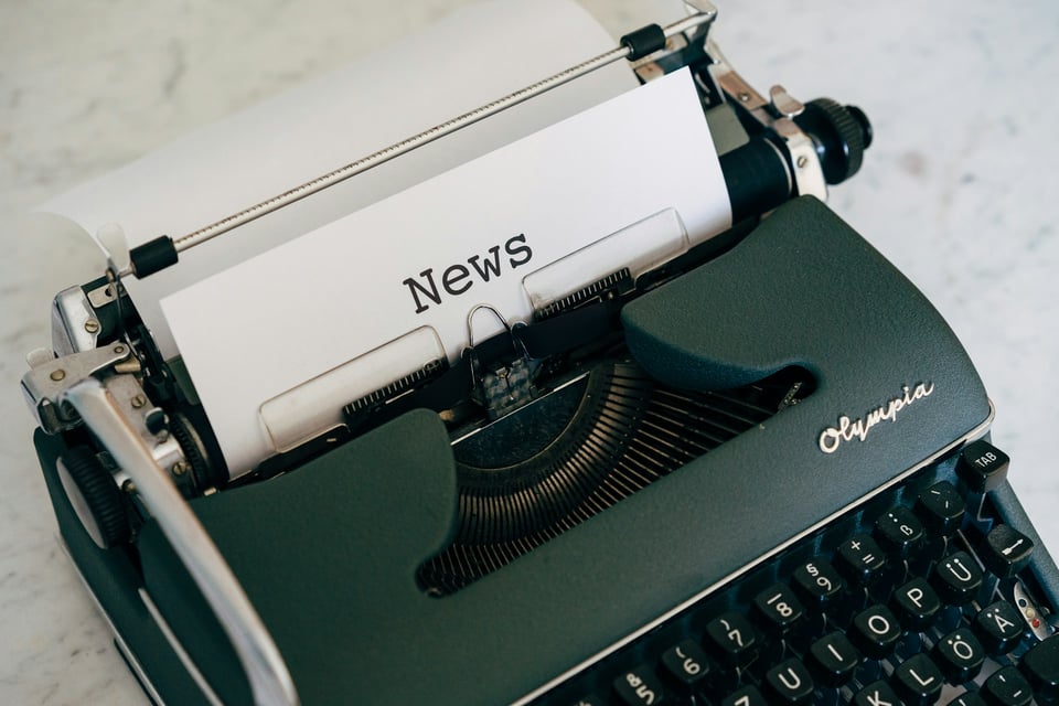 A close-up of a typewriter. The sheet of paper reads "NEWS." Photo by Markus Winkler on Unsplash