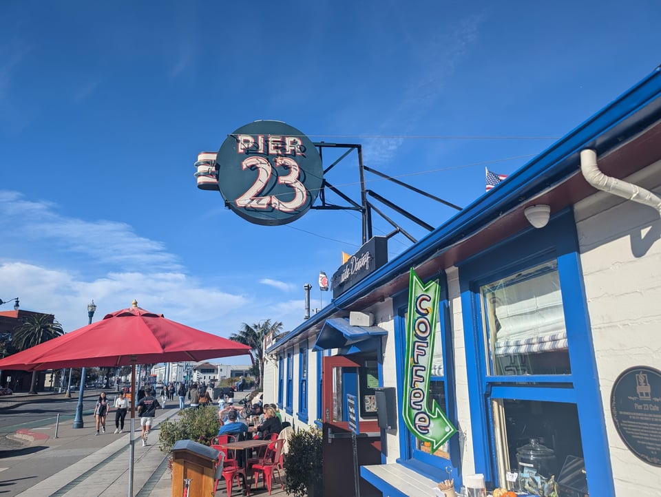 Pier 23, with a cute neon sign and an arrow pointing to coffee