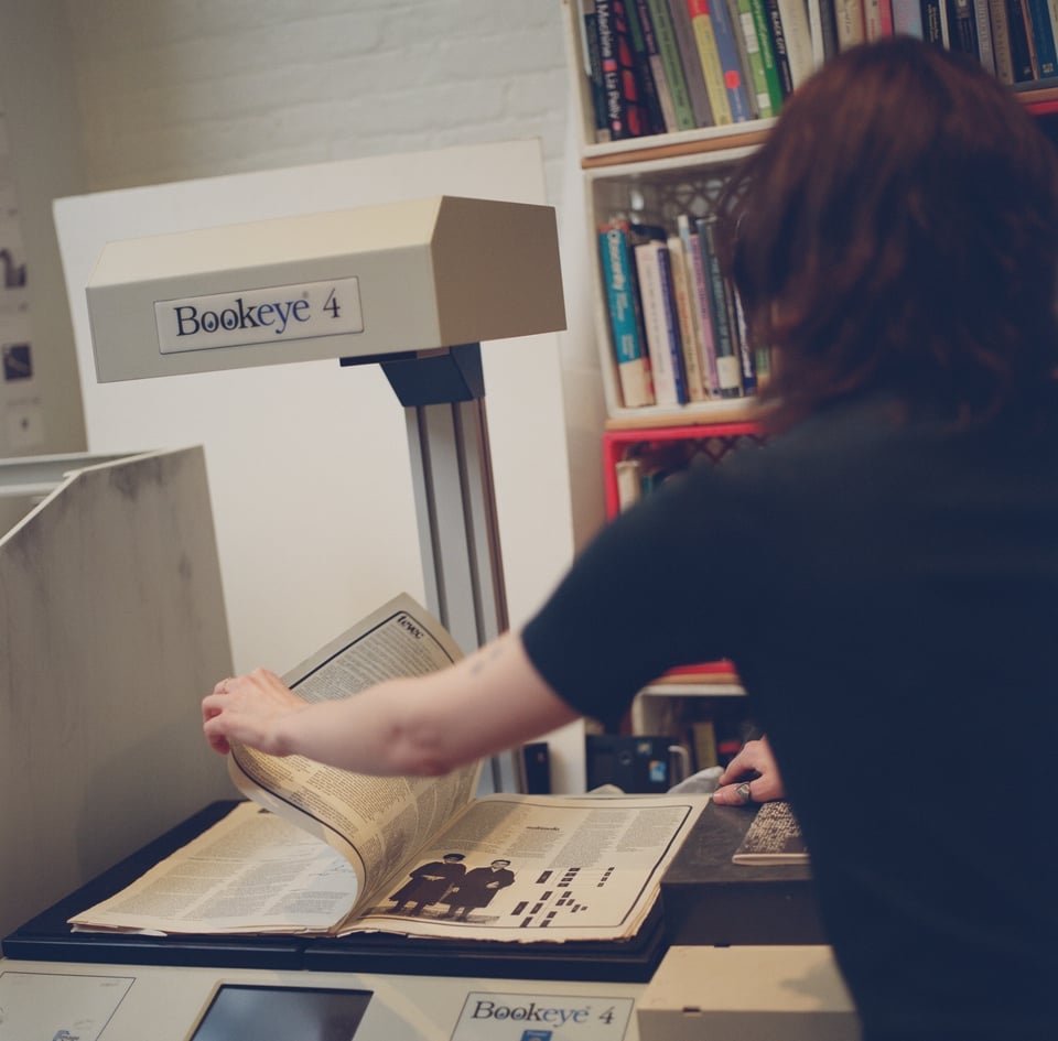 [Chaski scanning in books for the image library.]