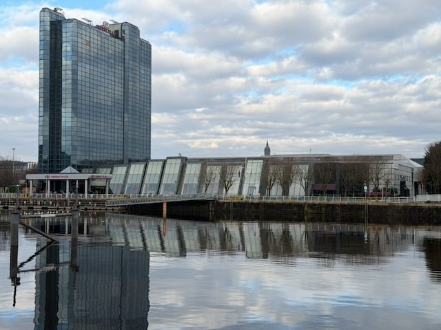Photo of the Crowne Plaza Hotel: a tall glass-clad building with a long, low function suite to the right of it