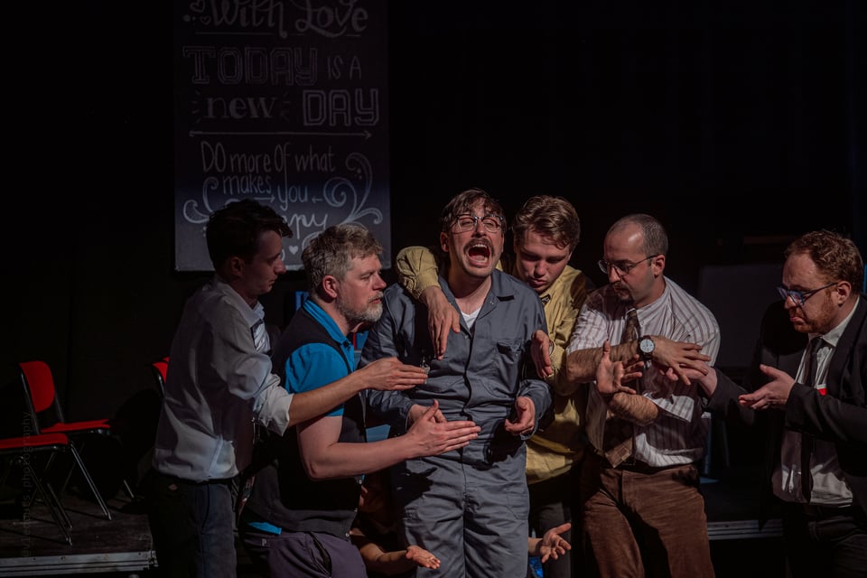 A group of actors creating a machine