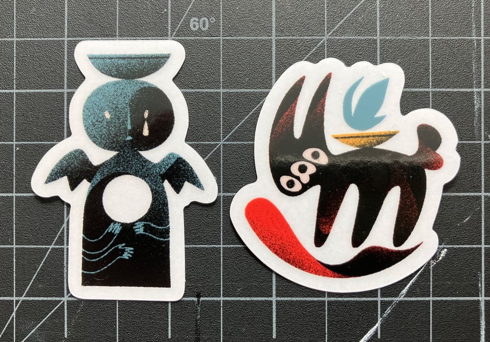 Two stickers, an angel statue and an abstract goat demon