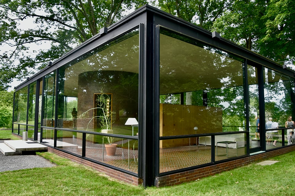 A one-story house with floor-to-ceiling glass windows.