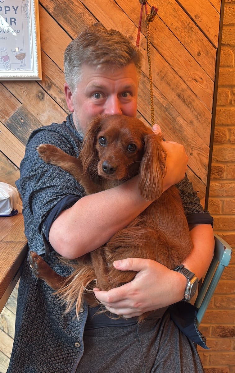 Me cuddling my dog.