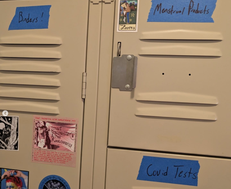 Lockers labeled "MENSTRUAL PRODUCTS" "COVID TESTS" and "BINDERS!"