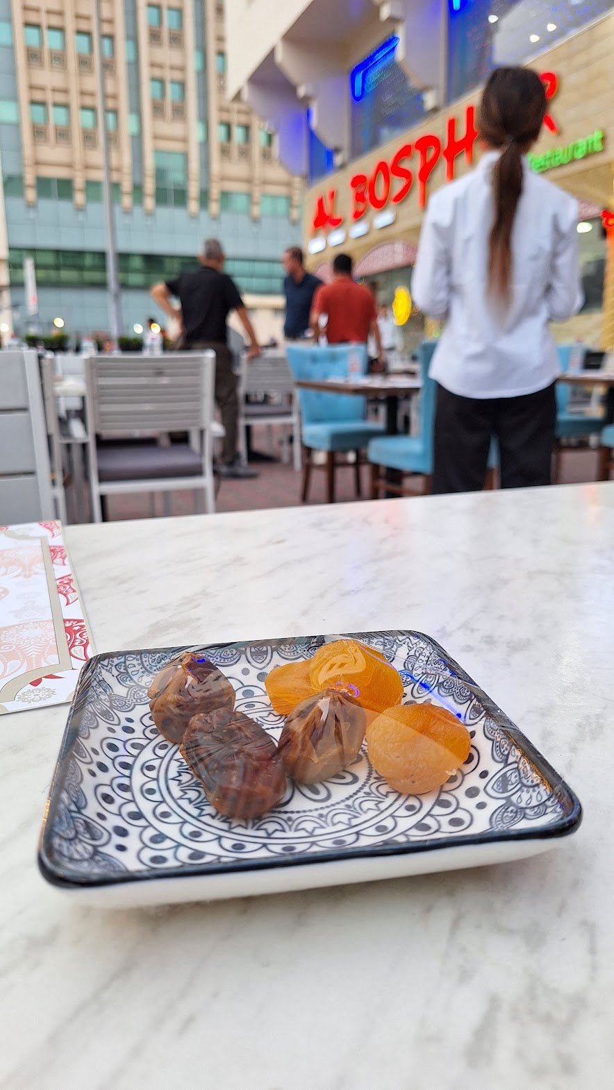 A plate of dried fruit on a table in a restaurant
