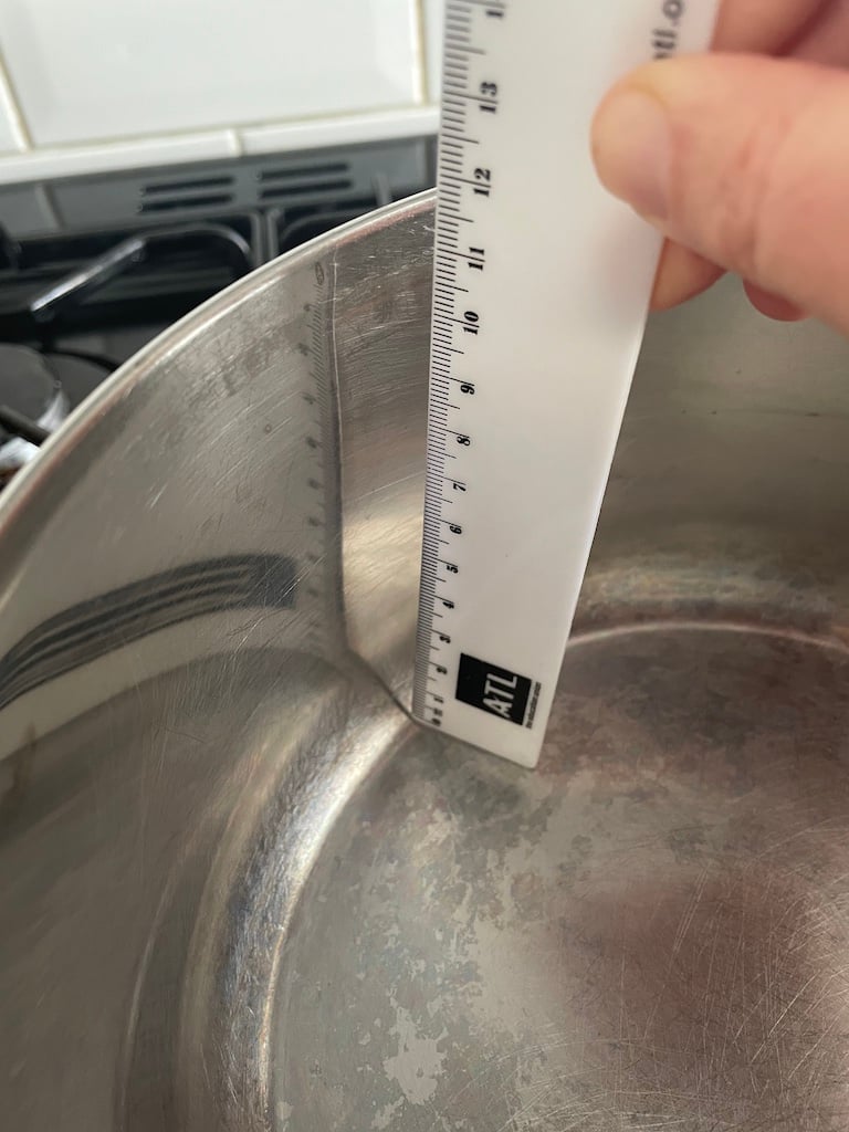 A ruler measuring a pot