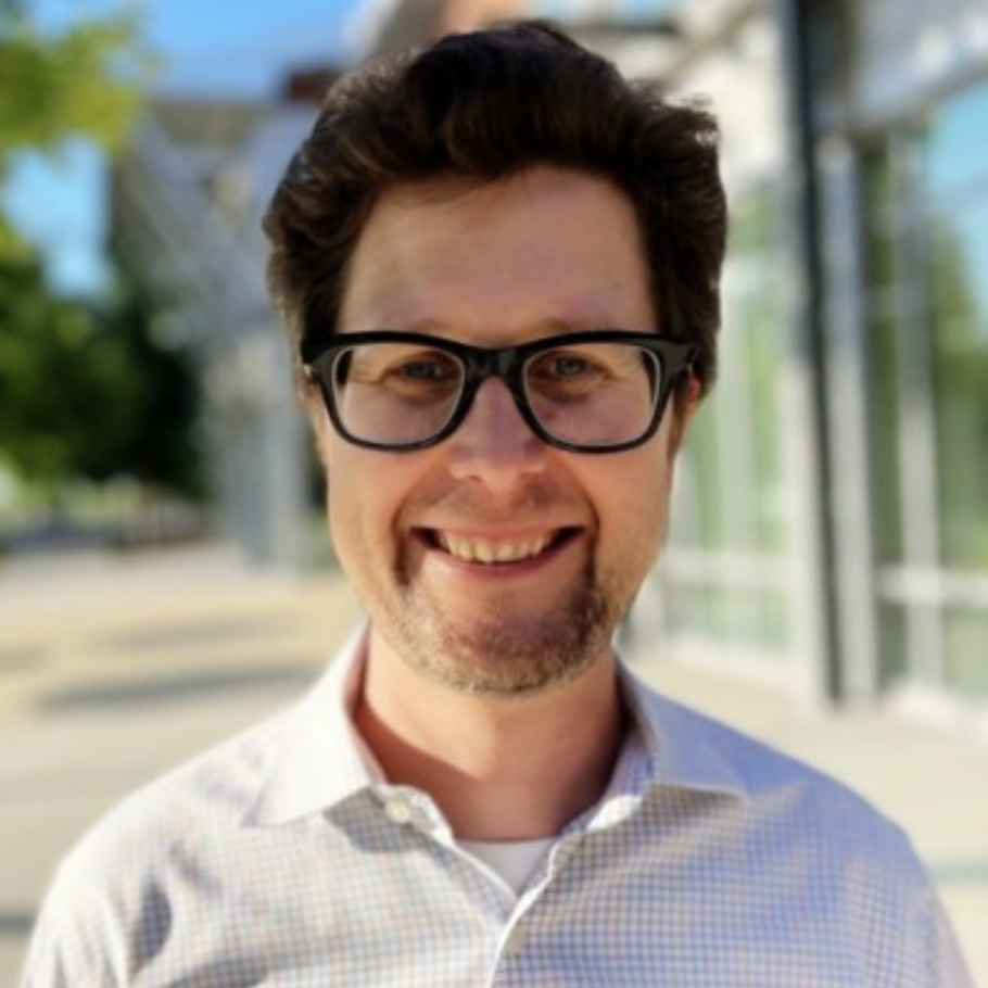 a man wearing glasses and a checkered shirt