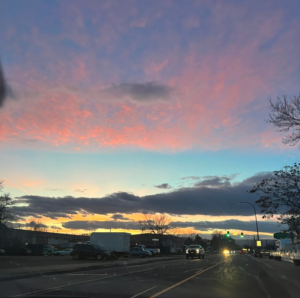 Pink skies over a city street at twilight