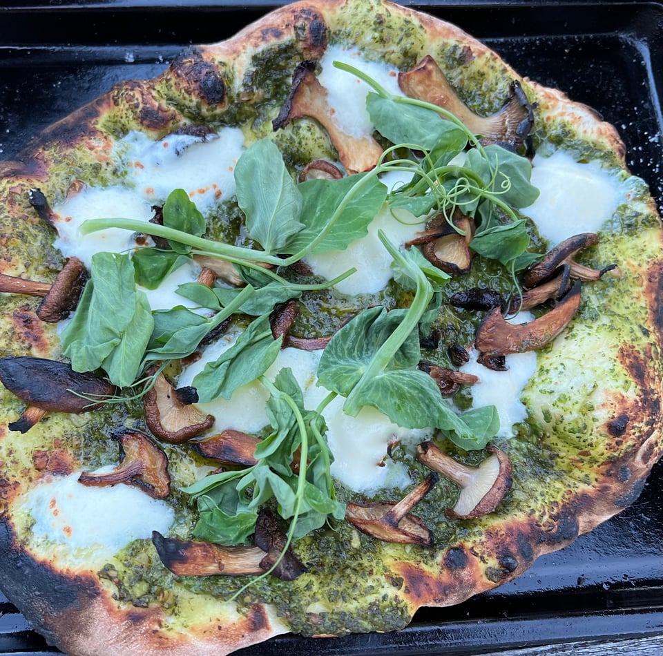 Chimichurri, fresh mozzarella, shiitake, and pea tendril pizza.