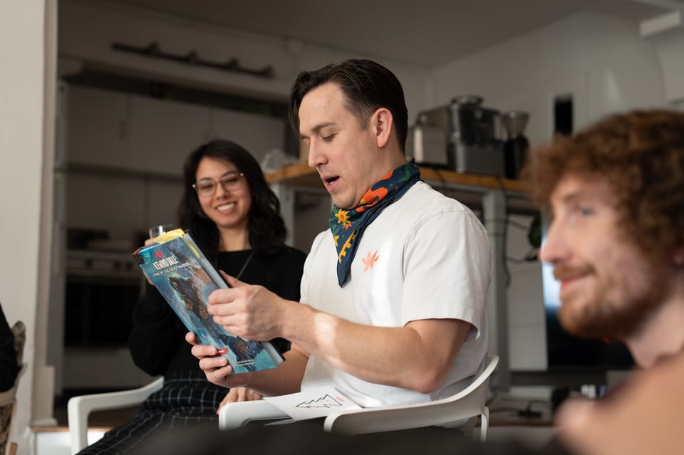 Dan holding what might a book.