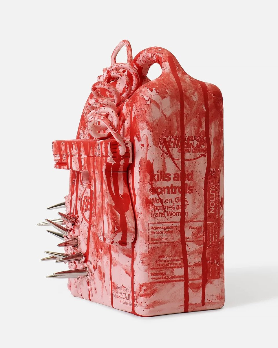 A ceramic sculpture resembling a pesticide jug, glazed in pink and streaked with dripping red, bearing mock label text reading "kills and controls: Women, Girls, Femmes and Trans Women," with coiled tendril forms twisting around the handle and a row of sharp metallic spikes protruding from its left side, photographed against a plain white background.