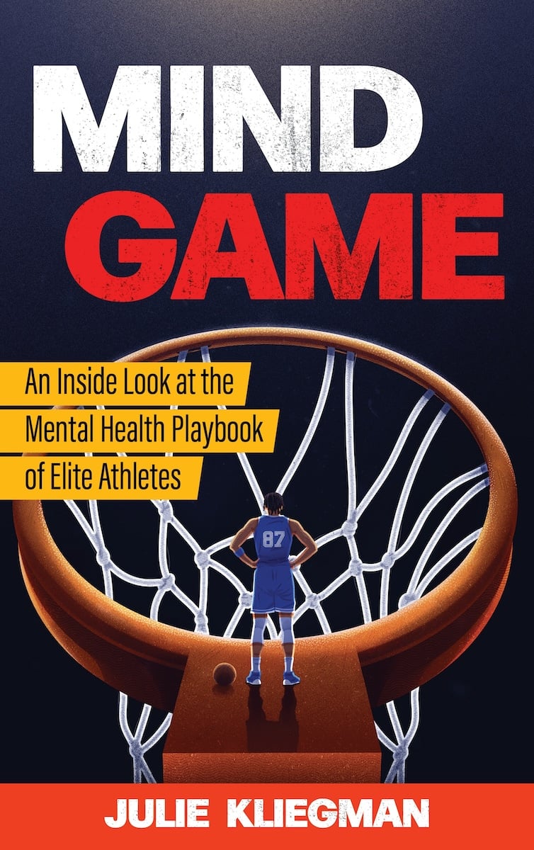 The cover of the book Mind Game: An Inside Look at the Mental Health Playbook of Elite Athletes by Julie Kliegman. There’s an illustration of a man standing on the rim of an oversized basketball hoop.