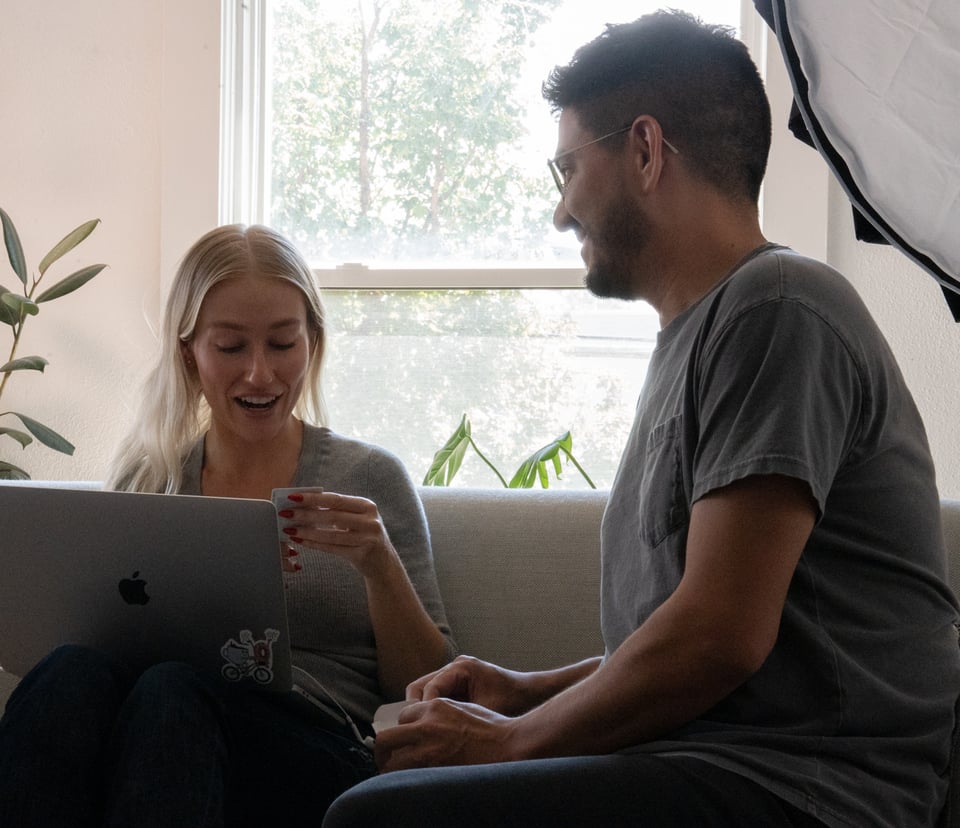 A beautiful woman looking surprised at a thoughtful gesture from a beautiful man.