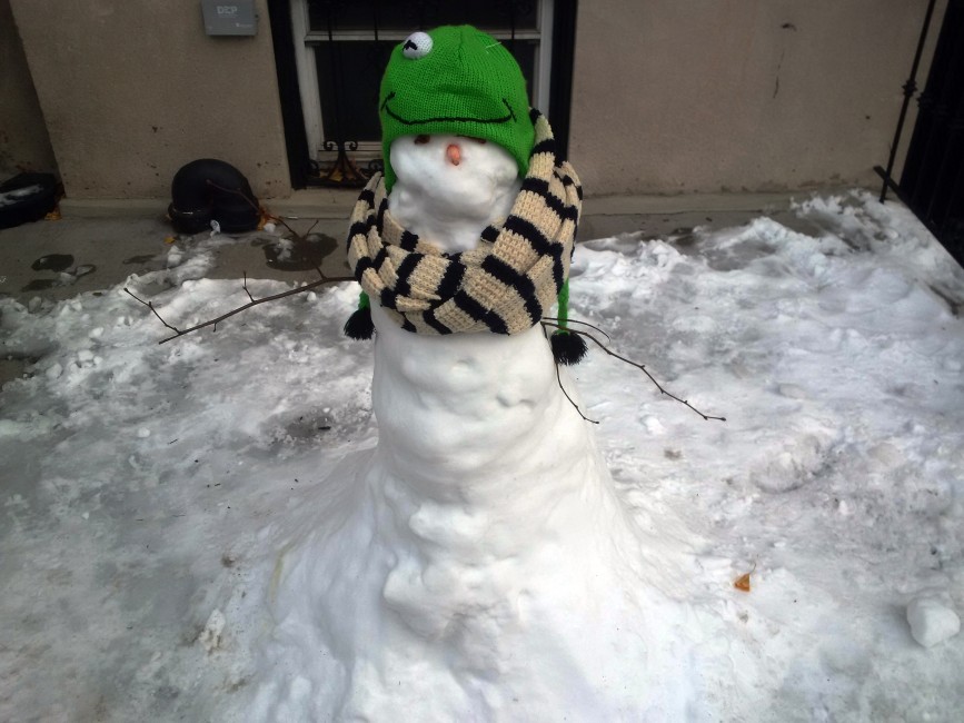 A snowman with a one-eyed frog hat seen in Carroll Gardens, Brooklyn.